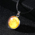Luminous moon and constellation pendant necklace on a chain with an extension, shown in one of ten possible colours.