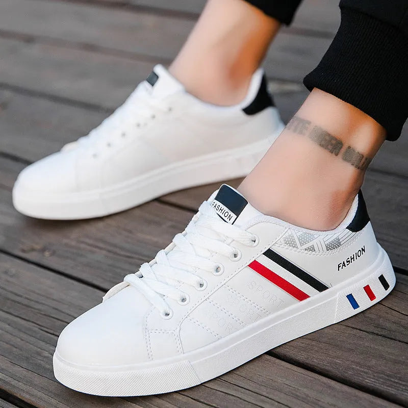 A pair of standard sports shoes shown in a choice of black, grey, or white colour.