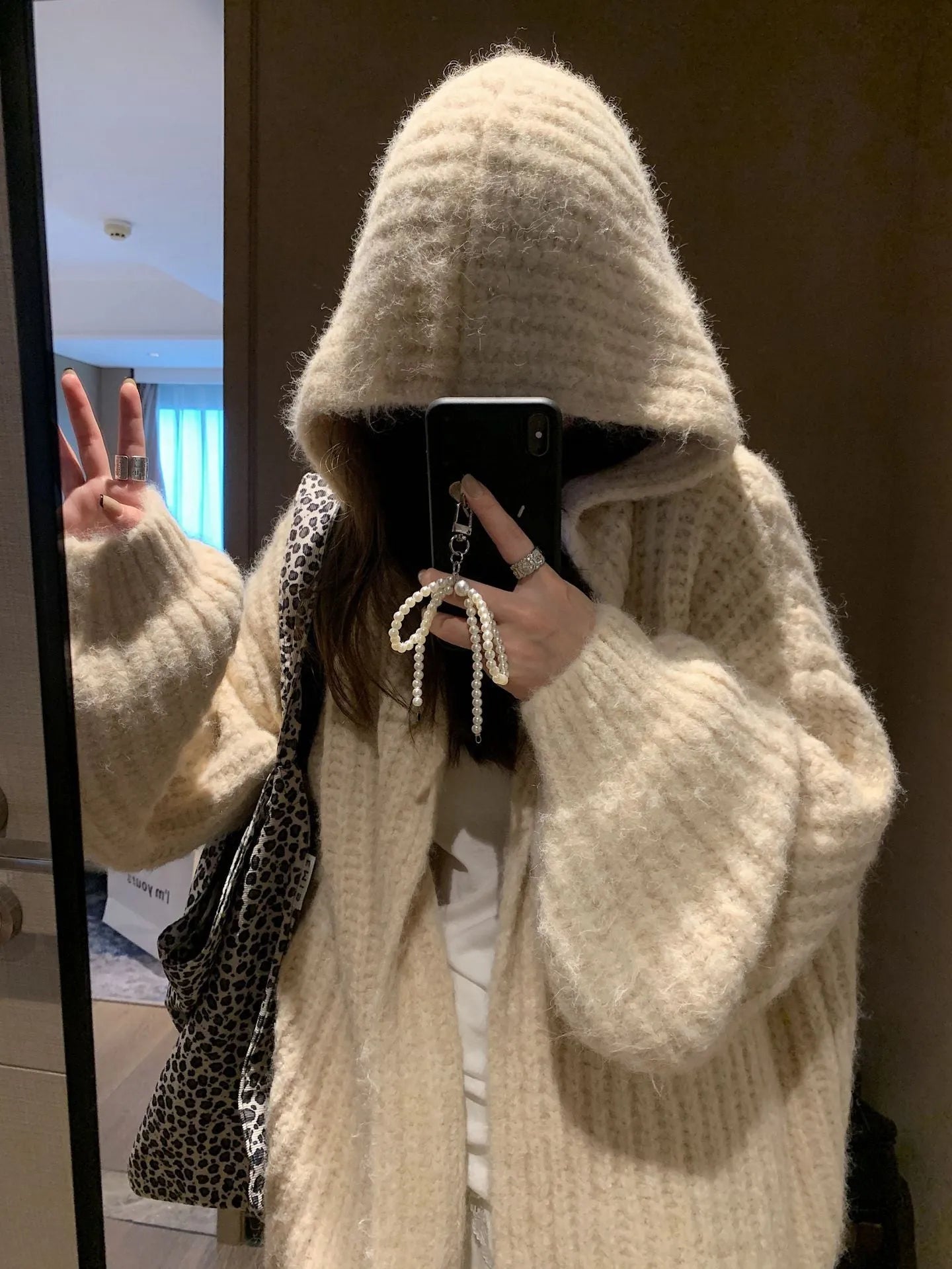 Women's thick grey retro Maillard style hooded cardigan sweater on a hanger
