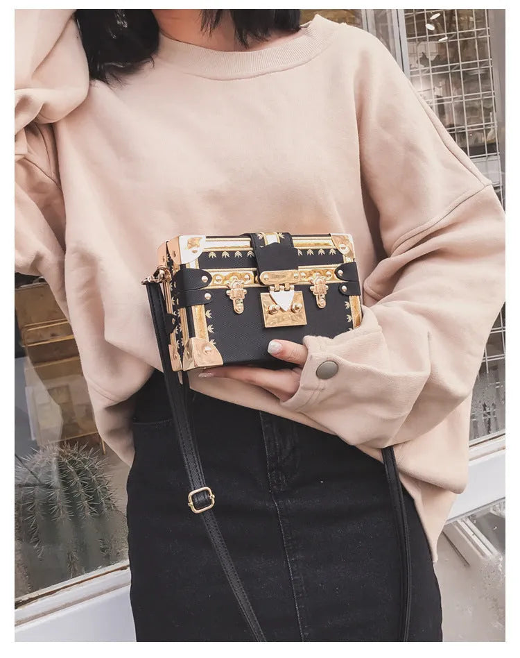 Women's hard-sided black PU shoulder bag with single strap and flap closure