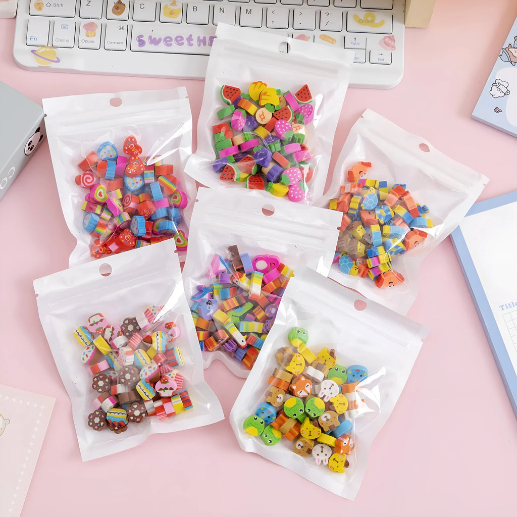 Open pearlescent film bag showing 50 small colourful cartoon fruit-themed rubber erasers.