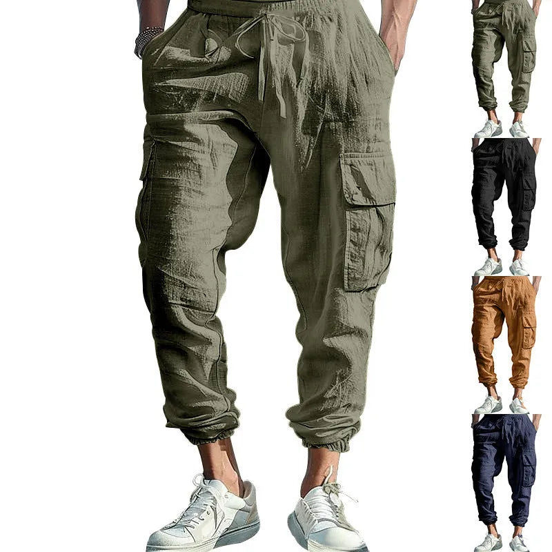 Man wearing loose-fit linen trousers with ankle-tied cuffs and a multi-pocket tether detail.