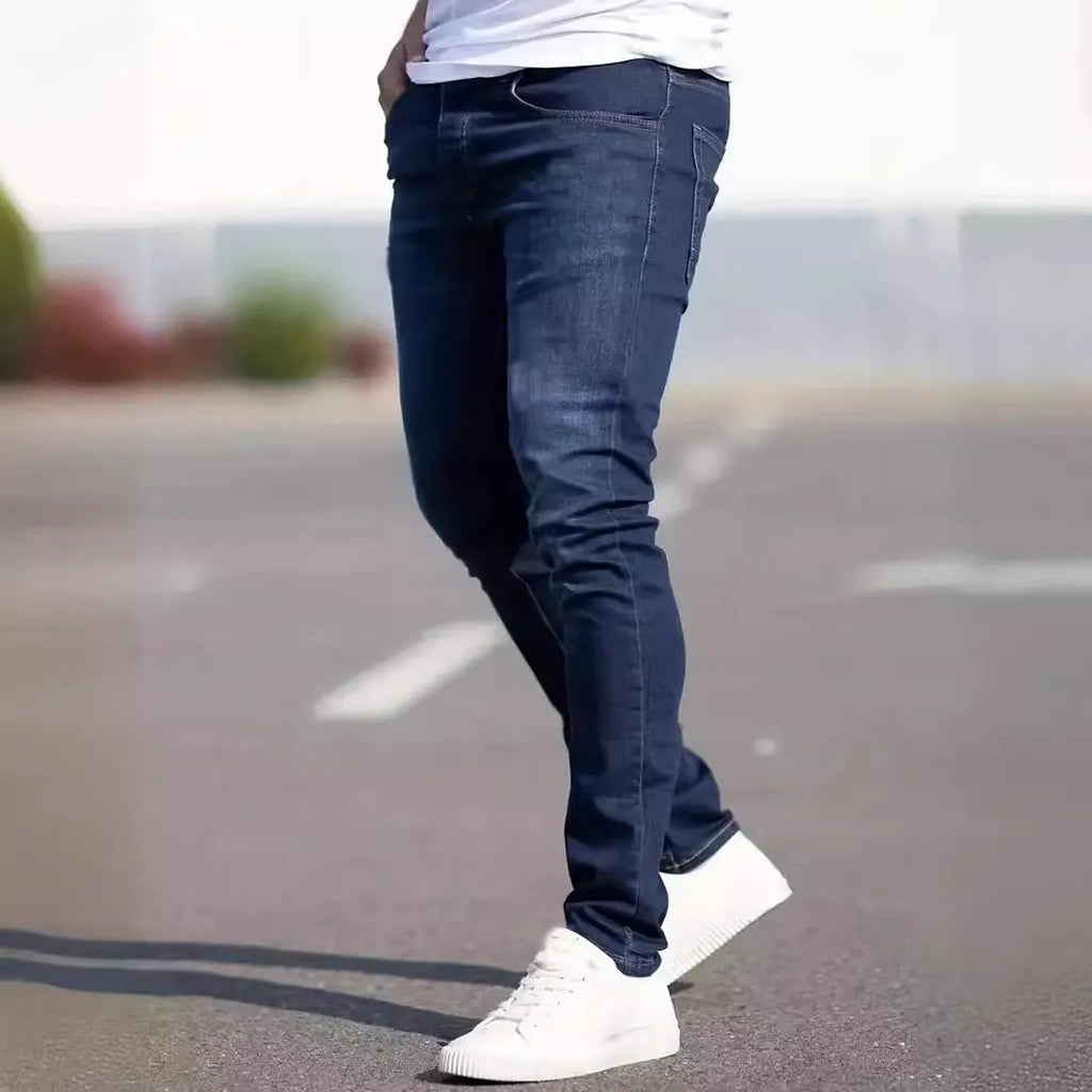 Men's dark blue slim-fit casual jeans with skinny leg and zip fly.