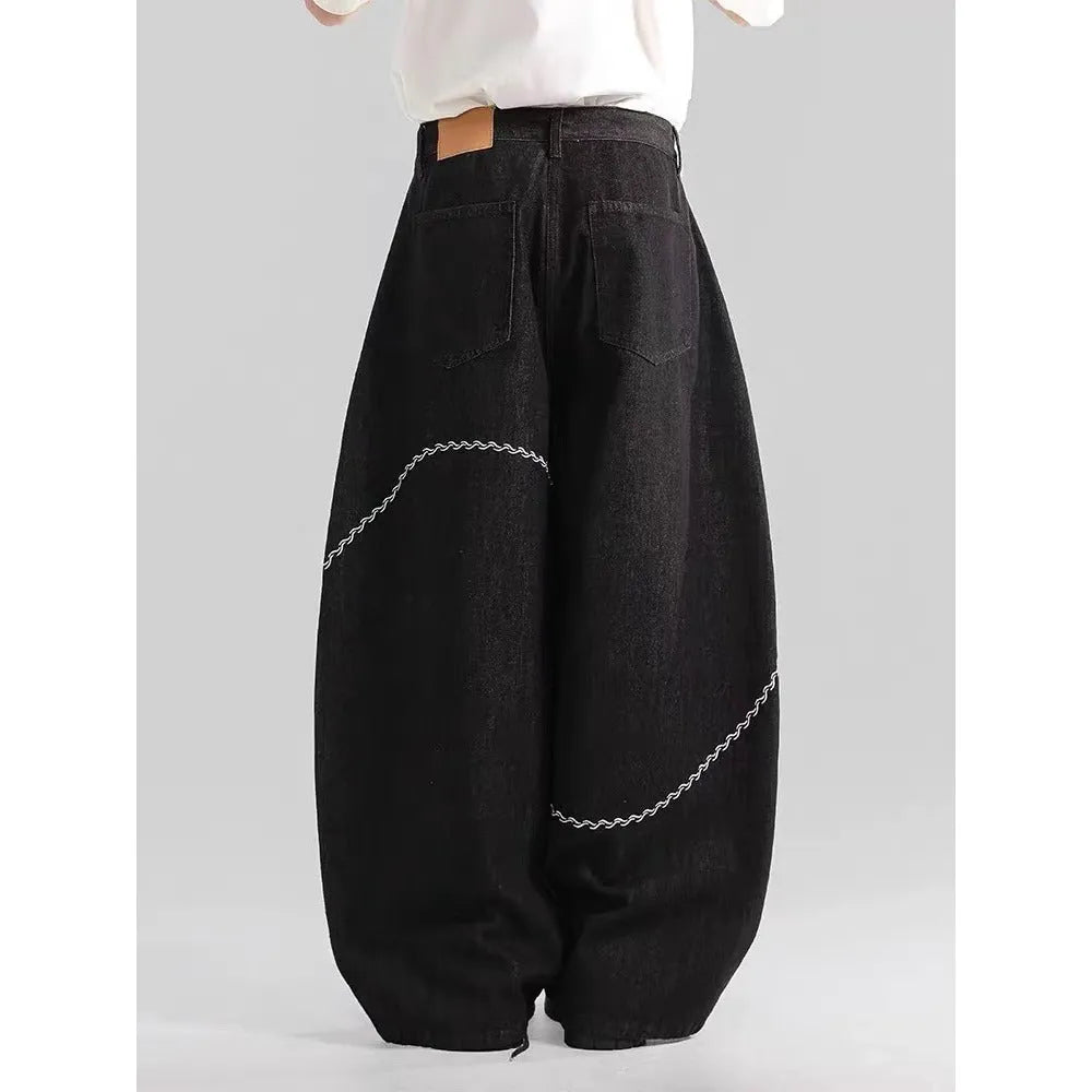Black straight-leg jeans with micro-elastic polyester denim fabric showing zip fly and mid-rise waist