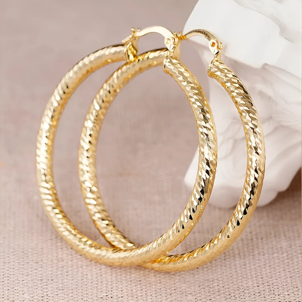 Geometric drop-shaped ear clips with ring and line design in metallic finish