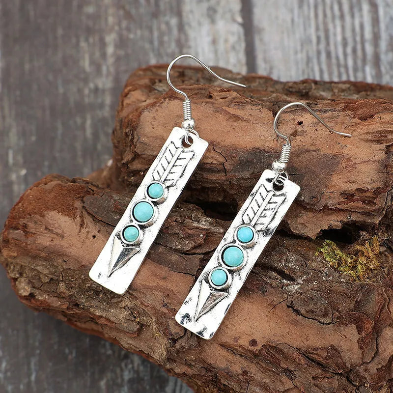Silver geometric drop earrings with turquoise stone inlay on long strip design