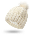 Women's knitted beanie hat with faux fur pom pom and satin lining in beige colour