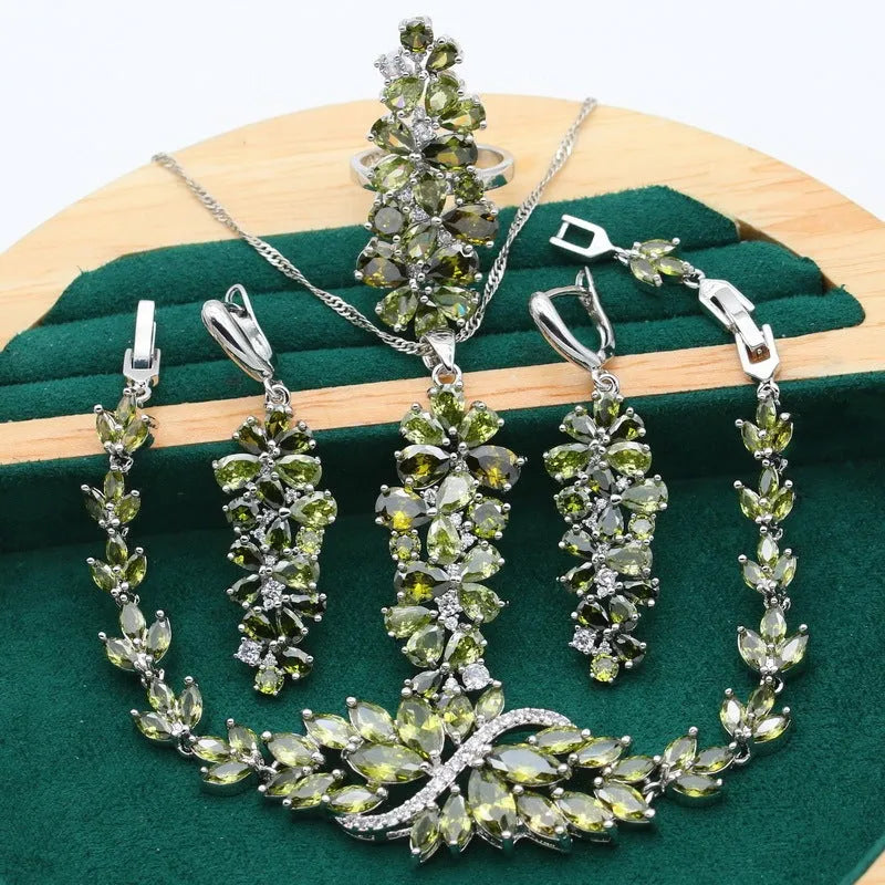 Complete retro jewellery set with floral pattern showing necklace, bracelet, earrings, and ring in olive, purple, or colourful finishes