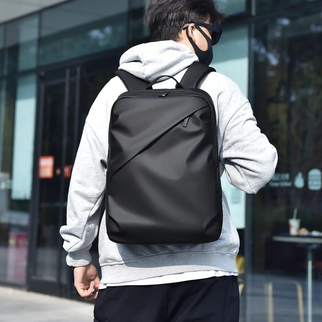 Waterproof PU leather laptop backpack in black, blue, and grey colour options