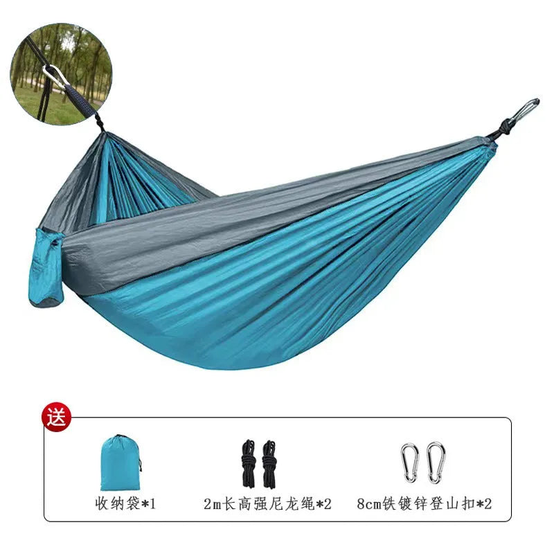 Blue nylon parachute cloth camping hammock measuring 270x140cm suspended outdoors