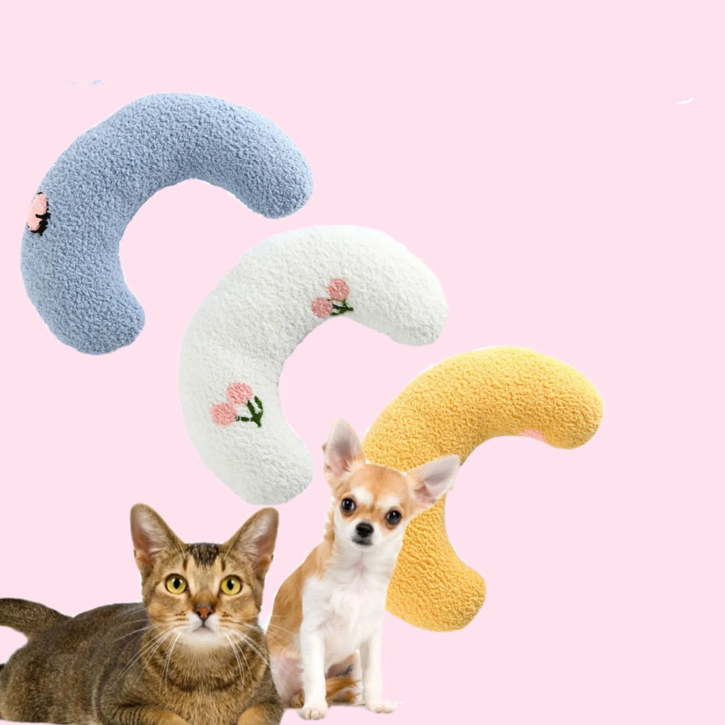 Small U-shaped plush pillow for cats and small dogs in blue colour, showing quilted faux fur texture.