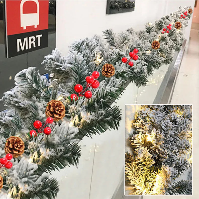 Snow-flocked artificial rattan Christmas garland in green and white on a wooden mantelpiece.