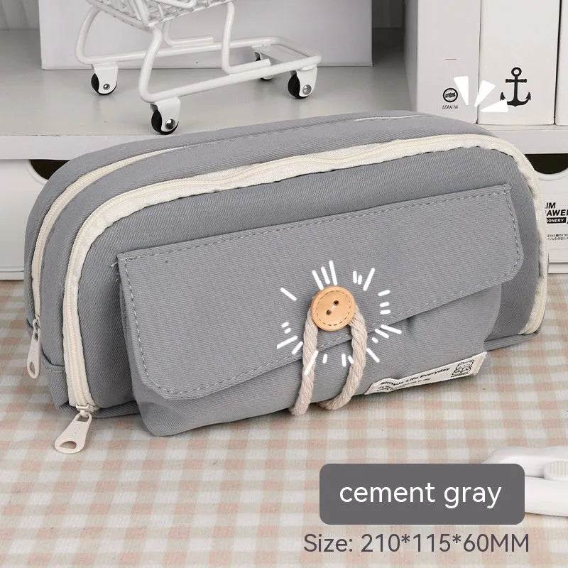 Korean style canvas pencil case in green, beige, blue, or grey, showing large capacity for pens.