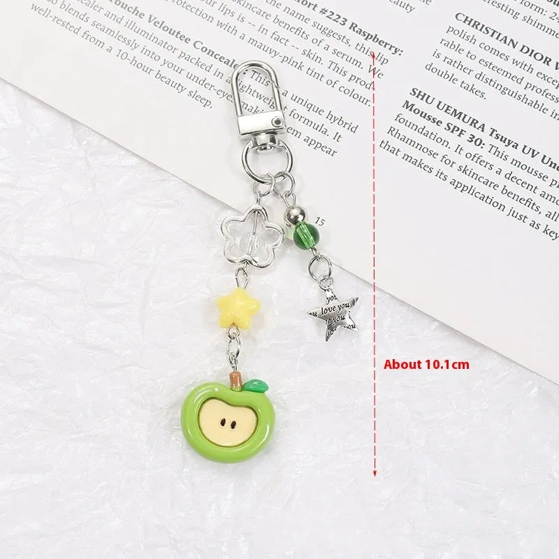 Cute fruit design mobile phone charm keychain in plastic resin with apple or strawberry motif.