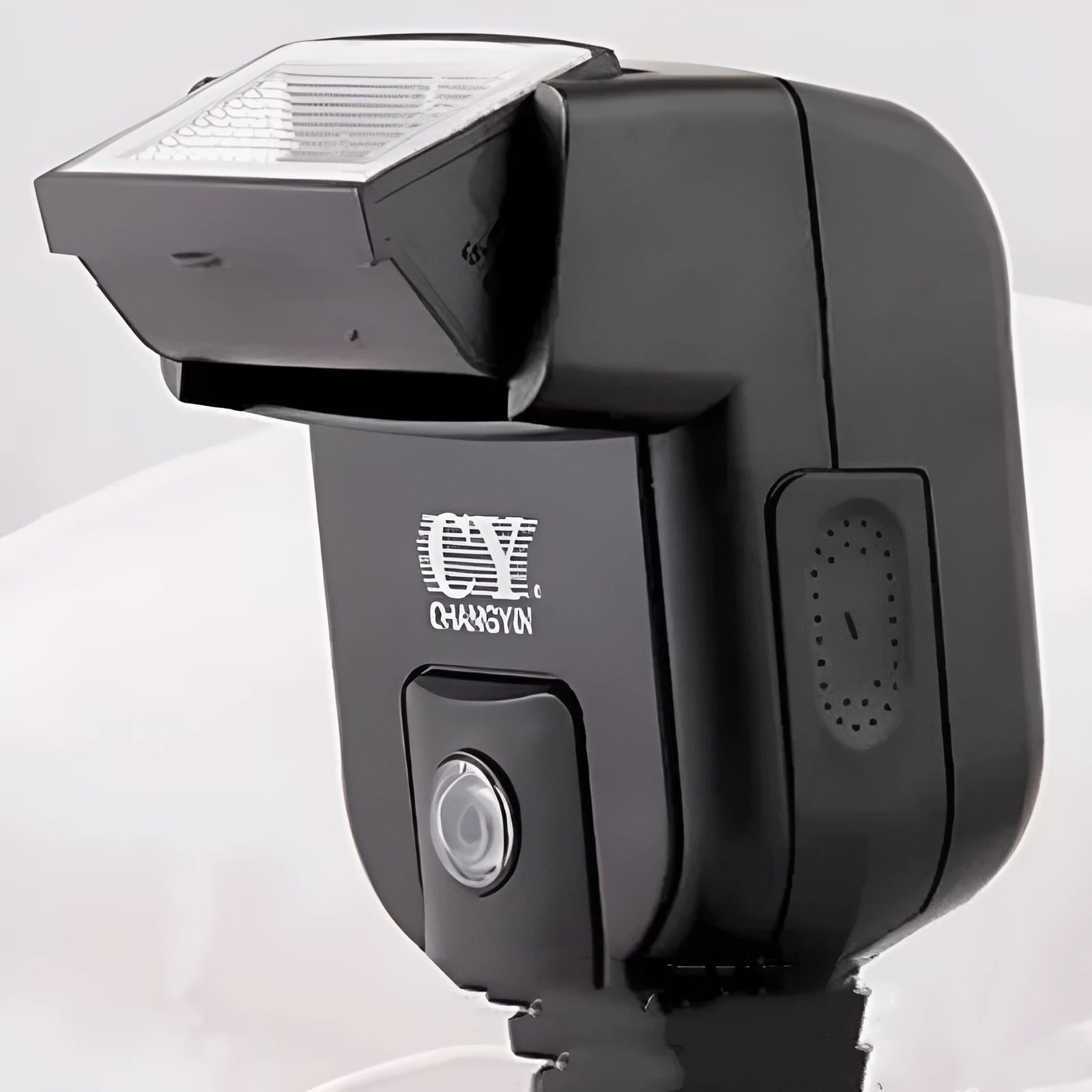 Compact black camera flash unit with tilt head showing GN20 specification and 5600K colour temperature label