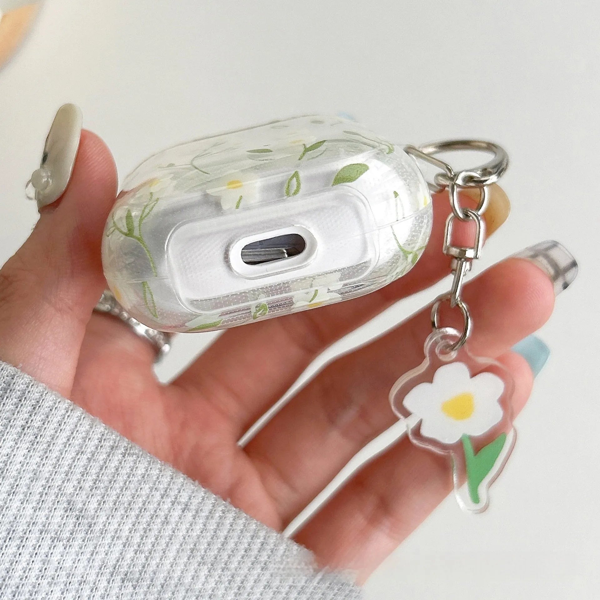 White floral design on a clear TPU protective cover for Apple AirPods case