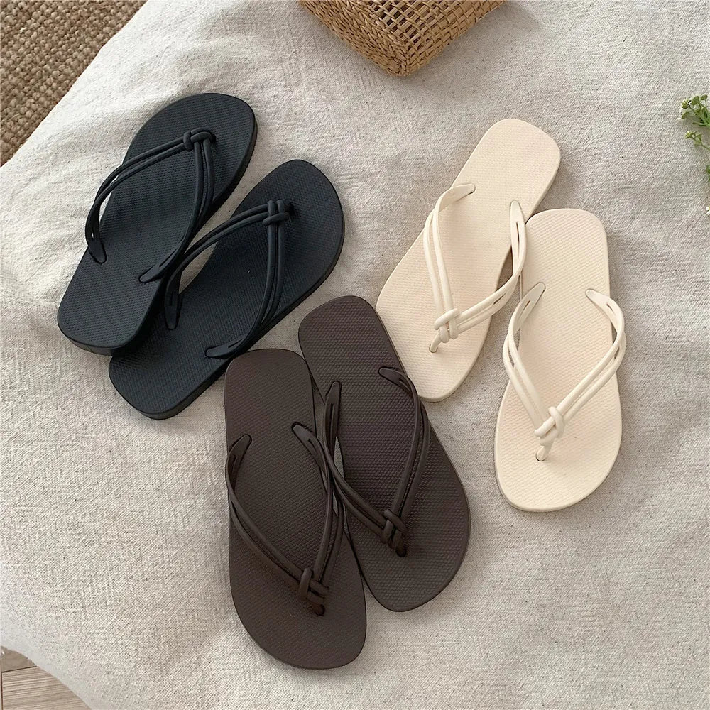 Women's pink PVC closed-toe flip flops with a non-slip sole on a plain background.