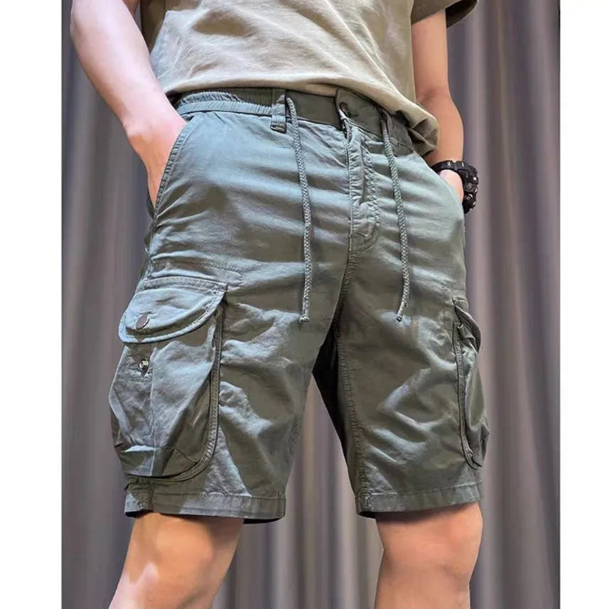 A pair of loose-fitting, straight-leg casual overalls in a khaki colour with multiple visible pockets.