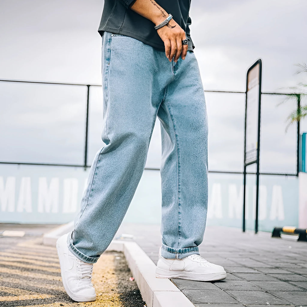 Men's loose straight jeans in dark blue, light blue, and grey colours showing mid waist and straight-leg cut