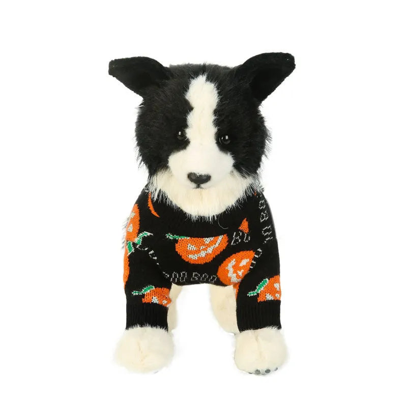 Black dog sweater with a large orange Halloween pumpkin pattern on the back, laid flat.