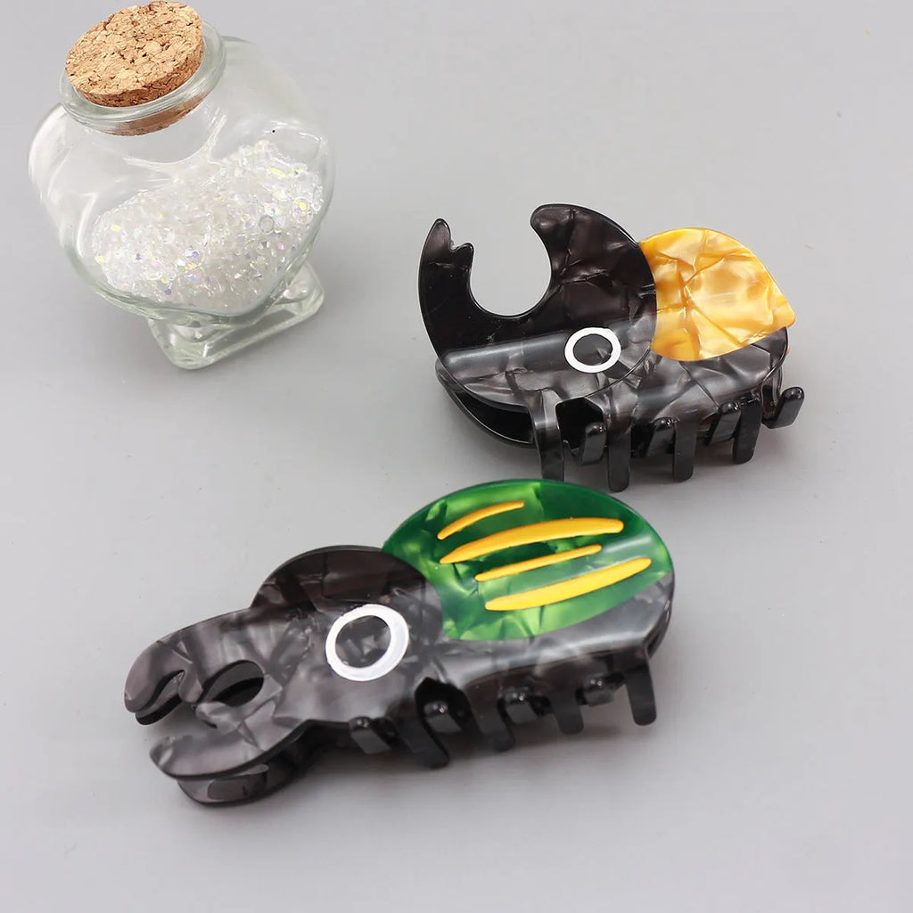 Cellulose acetate insect grip sheet with handmade beetle or caterpillar cartoon design