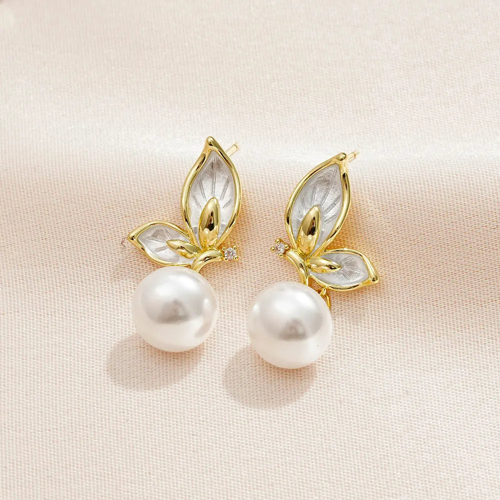 Butterfly-shaped drop earrings for women with oil painting design and zircon stone accents on copper.