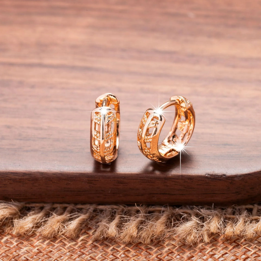 Copper hollowed-out leaf and heart shaped earrings with rose gold finish showing geometric patterns