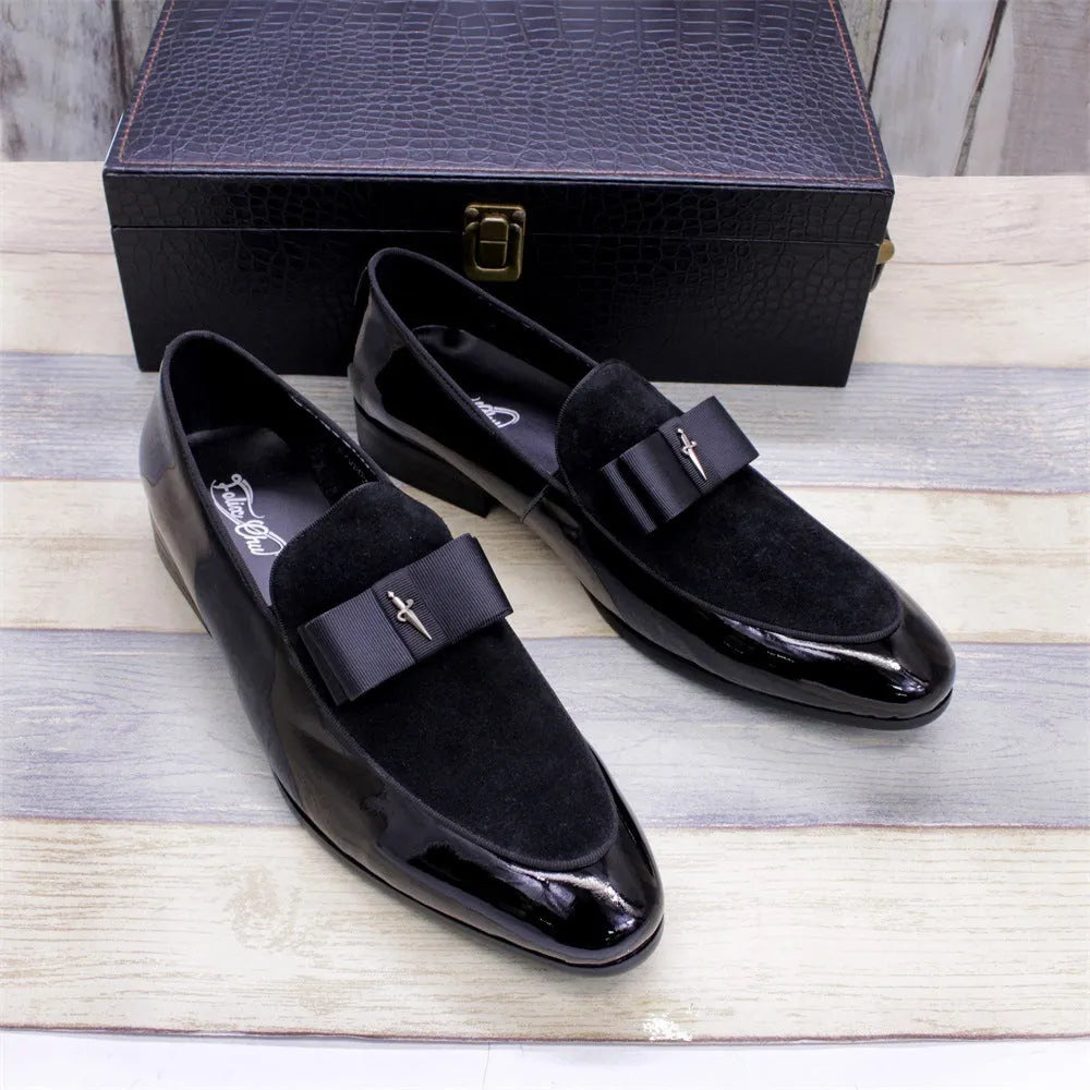 Men's black patent leather dress shoes with a tassel detail and low-top design on a rubber sole.