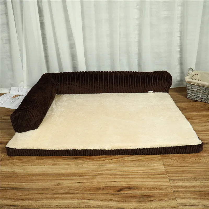 Corduroy dog sofa bed with bolster sides in a grey colour, shown on a wooden floor.