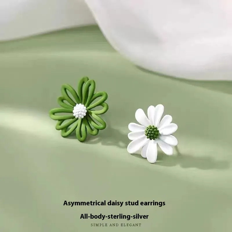 A pair of cartoon-style flower stud earrings made from alloy, showing a blue and orange two-tone colour variation.