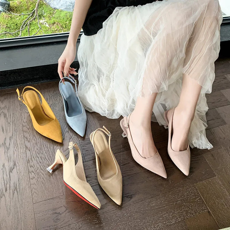 A pair of women's apricot suede stiletto heels with a pointed toe and thin high heel.