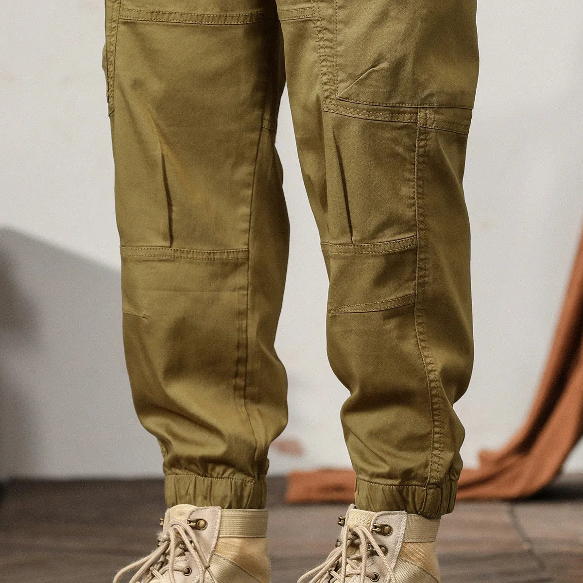 Men's cotton harem pants in khaki with tapered legs and ankle band.
