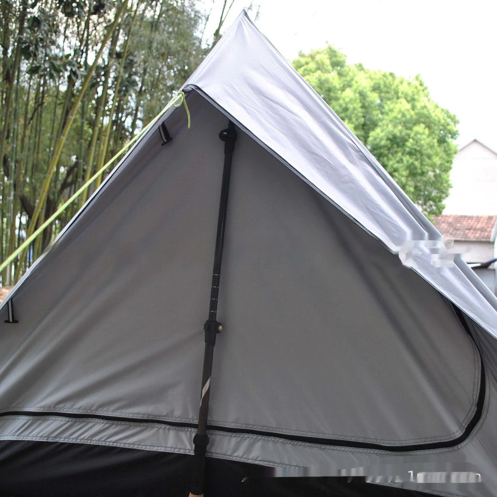 Brown and white pole-free A-line cabin tent set up with hiking canes, showing spacious interior