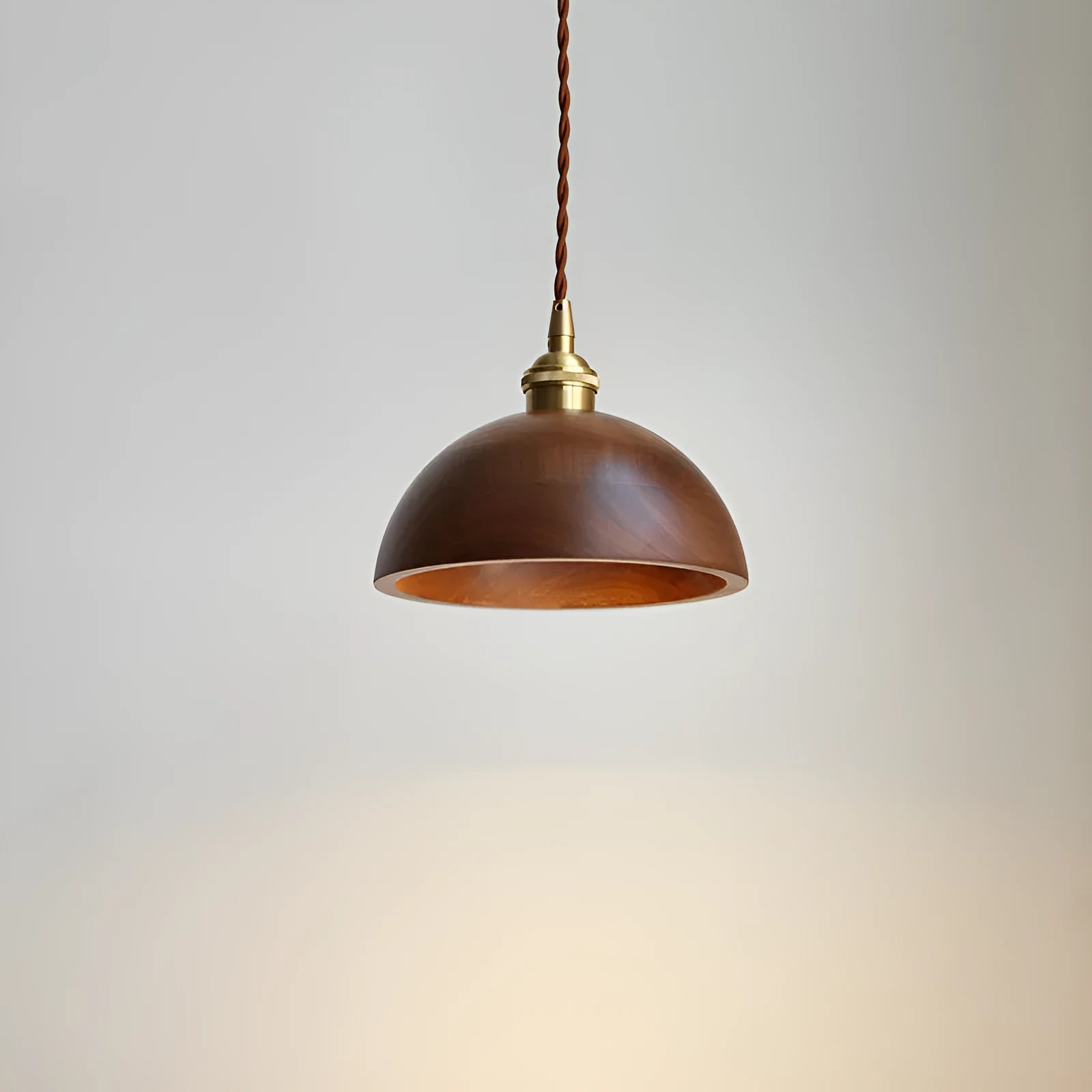 Close-up of a single-head droplight chandelier made from walnut wood art and copper, shown in one of four available colour styles.