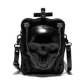 Black mini square crossbody bag with embossed skull design, metal chain strap, rivets, and contrast stitching.