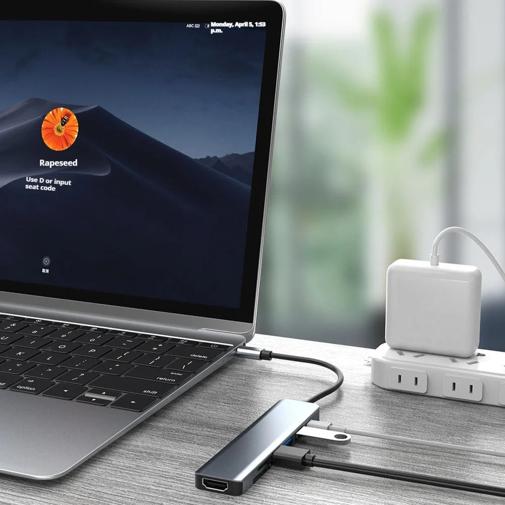 USB-C 7-in-1 hub expander with short cable, showing HDMI, VGA, and USB ports.