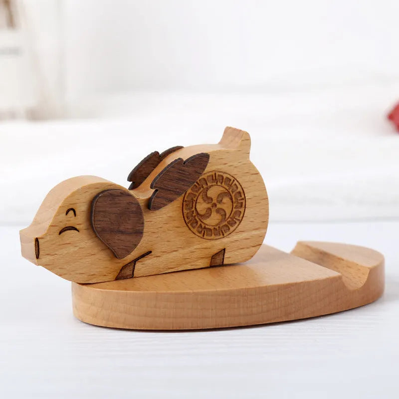 Beech wood mobile phone holder with resin animal decoration and custom lettering on coin back.