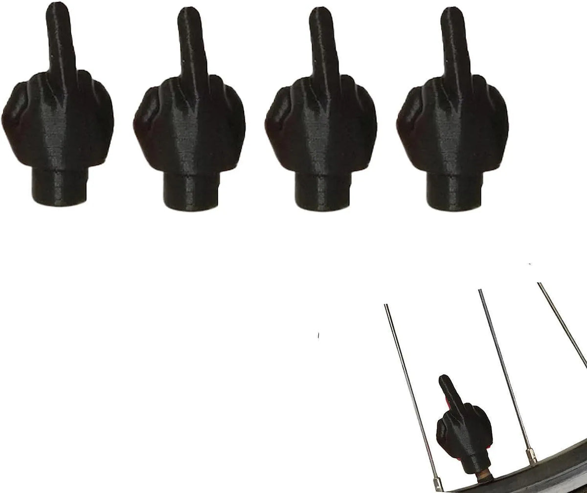 Four latex car tyre valve dust caps, two black and two skin colour, arranged together.