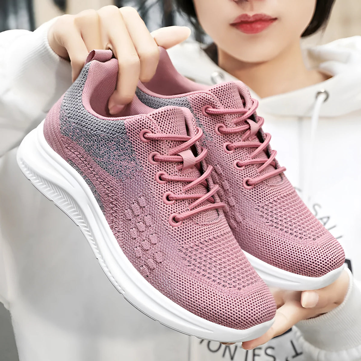 Women's low-top mesh sneakers with lace-up front and soft PVC sole in black, grey, or pink