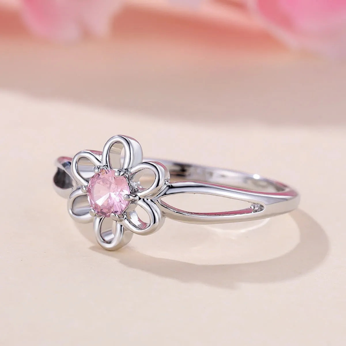 Women's fashion ring with hollowed flower pattern in electroplated copper, platinum pink diamond colour