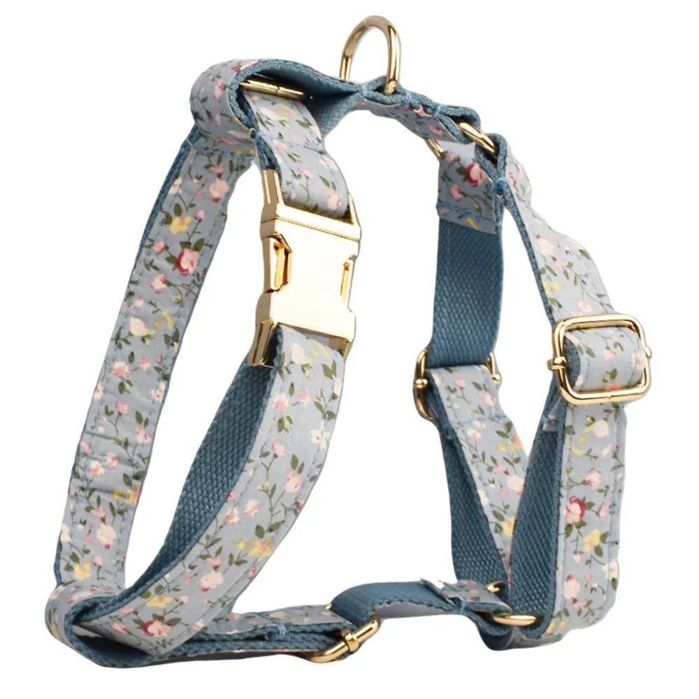 Blue floral pattern dog collar accessories set with adjustable collar, matching leash, bow, vest, and poop bag
