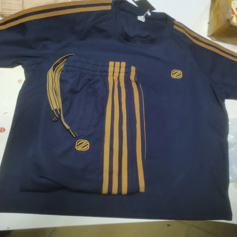 Man wearing a blue short sleeve sports suit set made from ironing-free polyester ice silk style fabric.