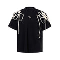 Black women's t-shirt with decorative ribbon trim padded shoulders and rivet detailing