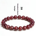 Natural strawberry quartz bracelet with geometric cherry red beads showing a starlight sparkle.