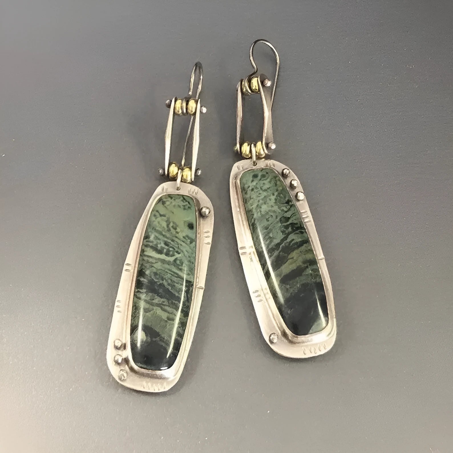 Two-colour marble pattern geometric alloy drop earrings on a white background.
