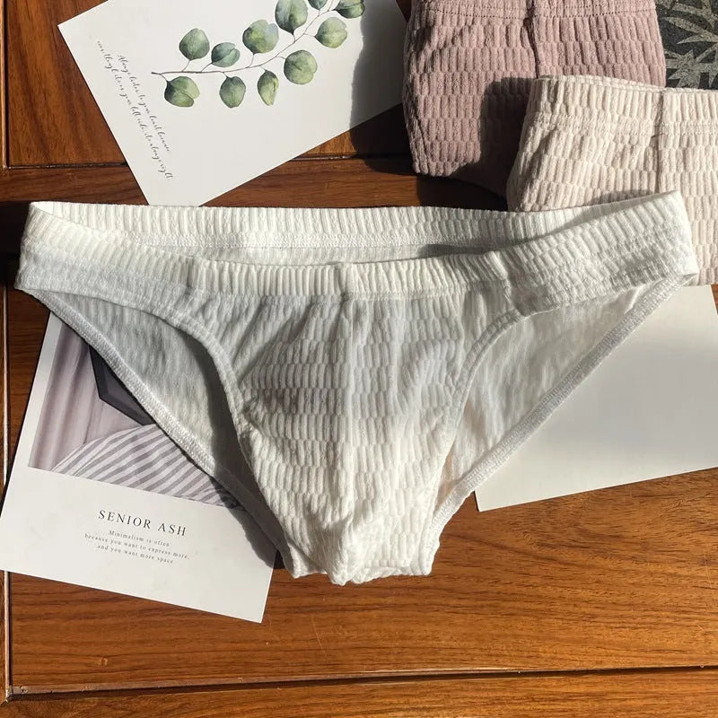 Men's solid colour pure cotton triangle briefs with a mid-waist waistband.