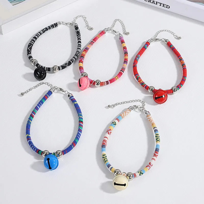 Coloured ethnic pattern adjustable pet collar with a bell for a dog or cat.