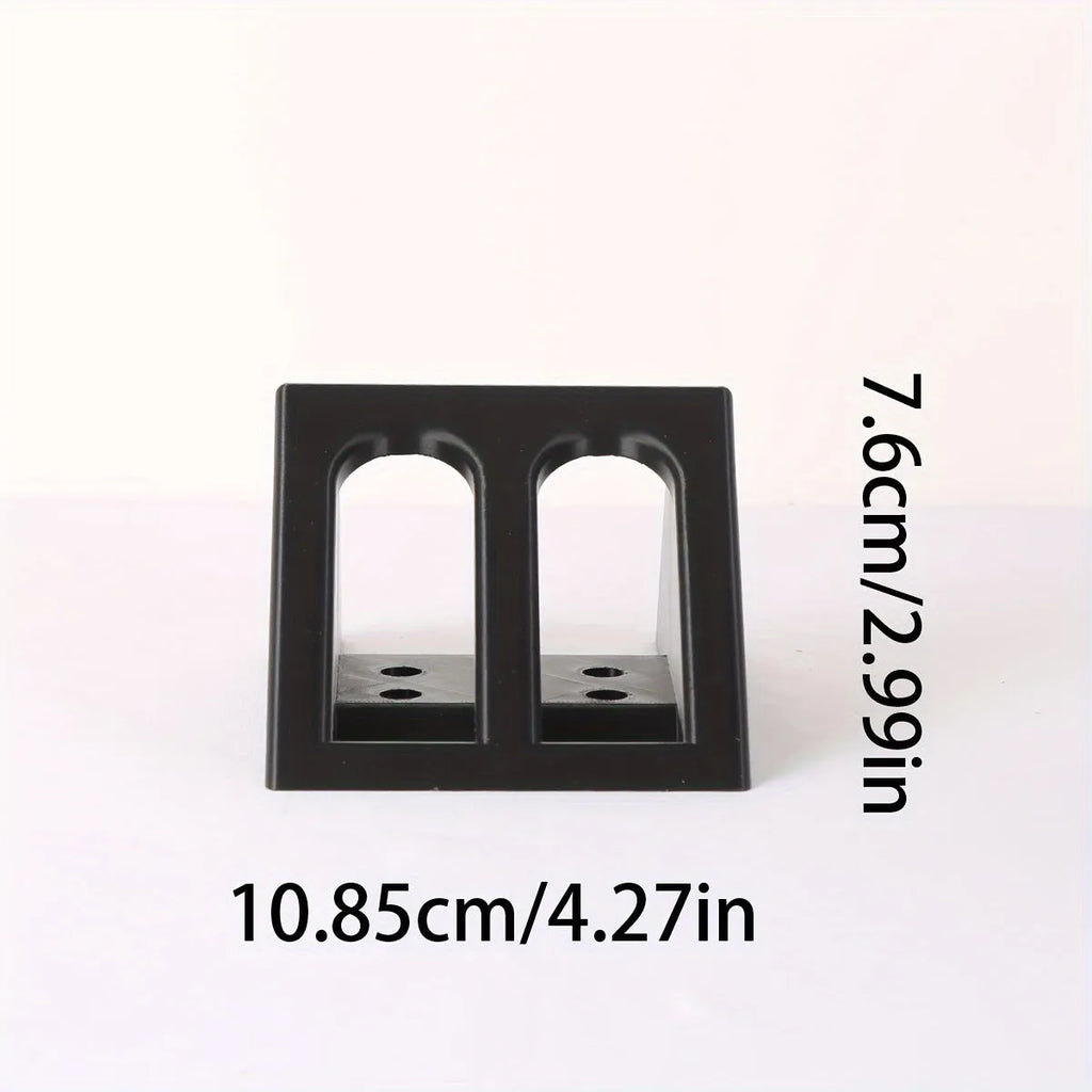 Black plastic punk-style pistol display stand on a flat surface.