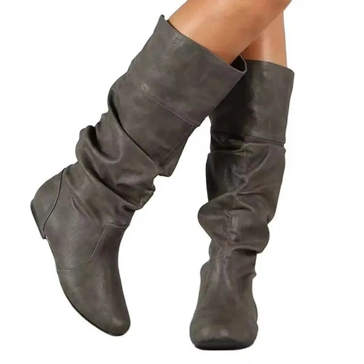 Women's flat round toe slip-on ankle boots in artificial PU leather with a high cylinder shaft.