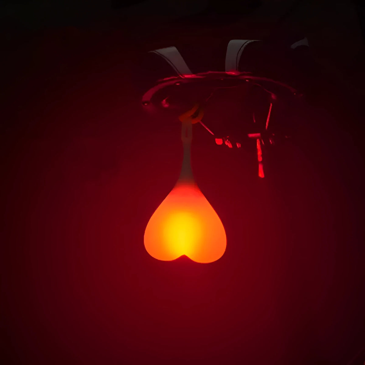 Heart-shaped silicone bike rear light, 15 cm long, touch activated, waterproof, in red blue green.